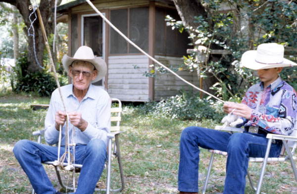 OKEECHOBEE  -- This 1994 photo shows apprentice J. Taylor Marcus being taught about the plaiting of cow whips from whip maker George "Junior" Mills.